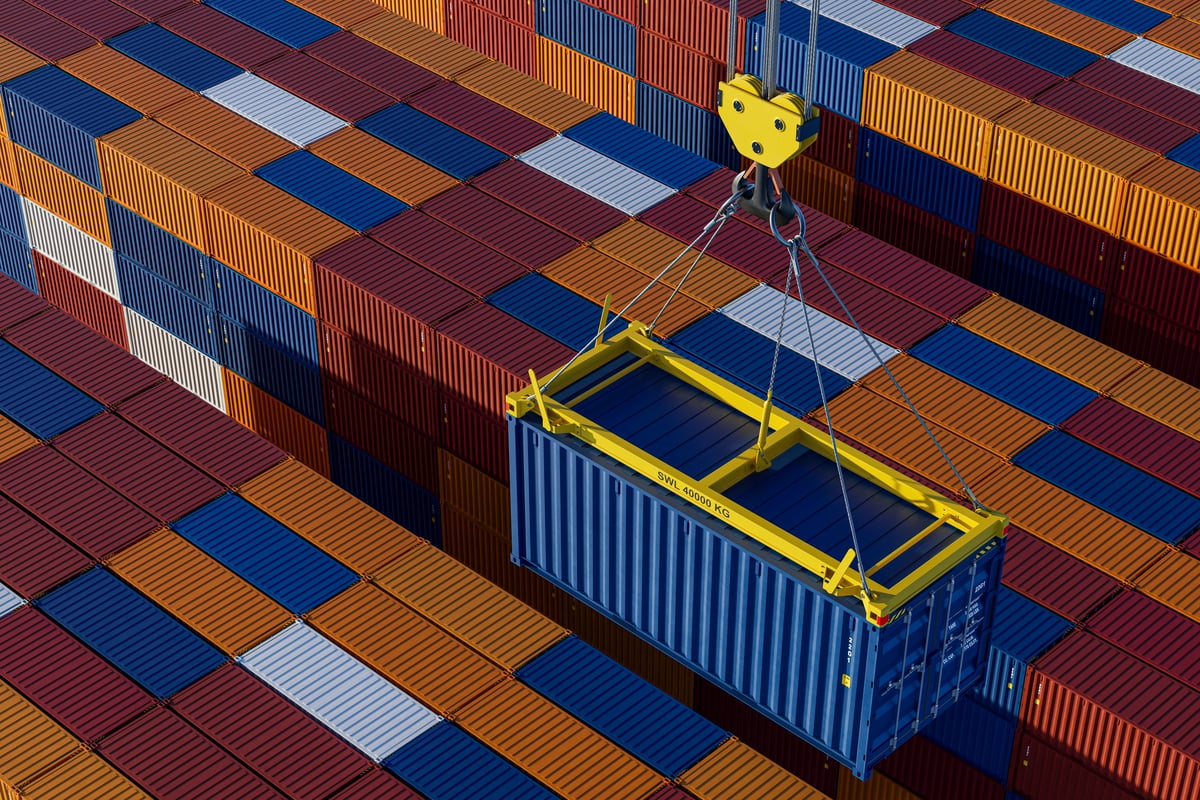 Crane lifting a shipping container at an industrial terminal